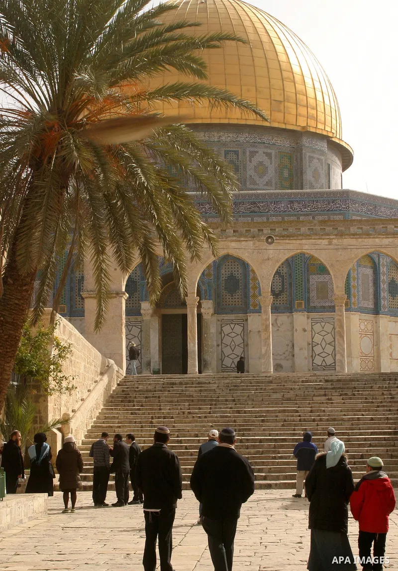 Palestinians and Jewish settler look to the dome of the rock at Al-Aqsa mosque in the old city of Jerusalem on Mar. 14, 2012. Photo by Mahfouz Abu Turk