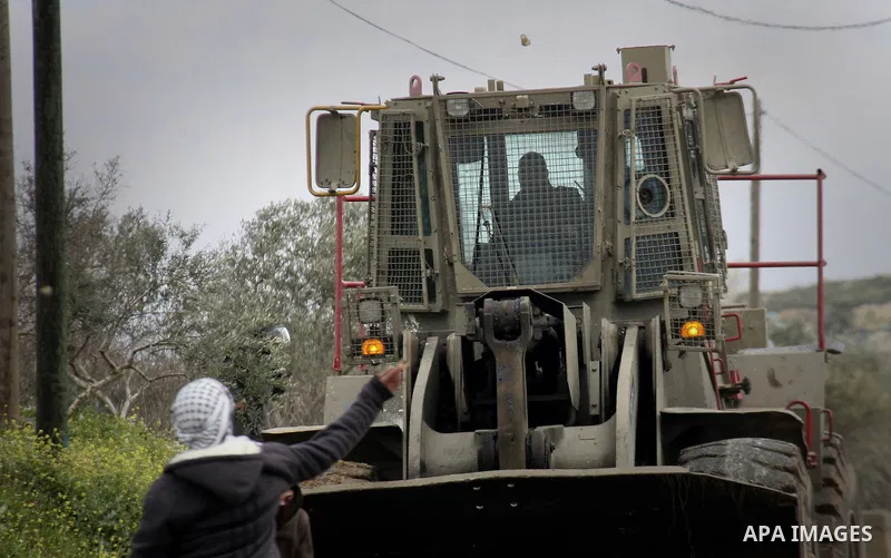 Palestinian youths hurl stones at Israeli security forces ,during a protest in the village of Kufr Qaddum near the Israeli settlement of Kdumim, in the northern West Bank, Friday,March 16, 2012. Photo by Wagdi Eshtayah
