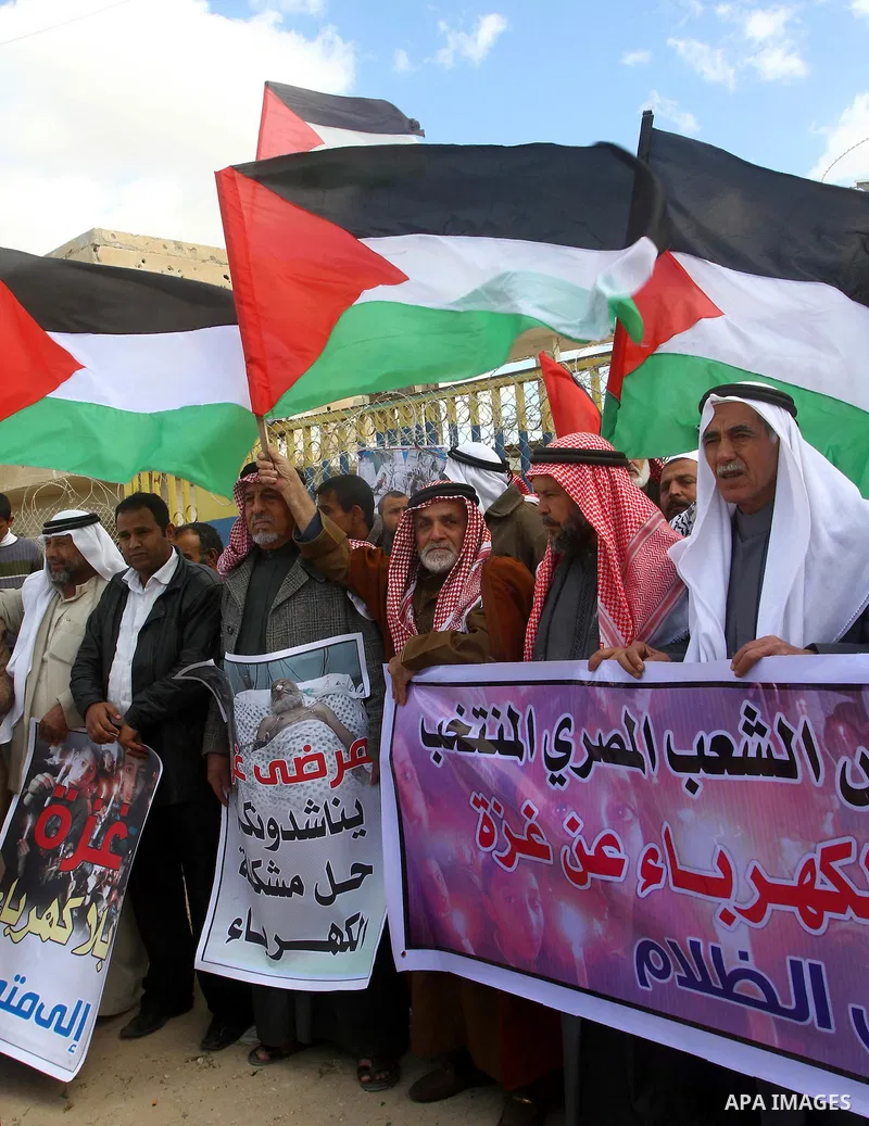 Palestinians attend a rally in front of the Rafah border crossing with Egypt on March 17, 2012, during a sit-in Rafah demanding Egypt provide the Gaza Strip with electricity and diesel. The Palestinian energy authority i...