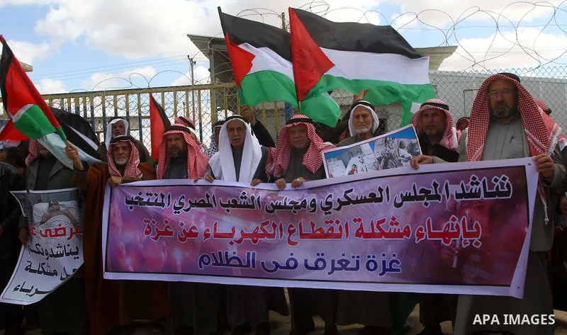 Palestinians attend a rally in front of the Rafah border crossing with Egypt on March 17, 2012, during a sit-in Rafah demanding Egypt provide the Gaza Strip with electricity and diesel. The Palestinian energy authority i...