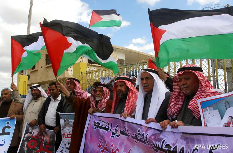 Palestinians attend a rally in front of the Rafah border crossing with Egypt on March 17, 2012, during a sit-in Rafah demanding Egypt provide the Gaza Strip with electricity and diesel. The Palestinian energy authority i...