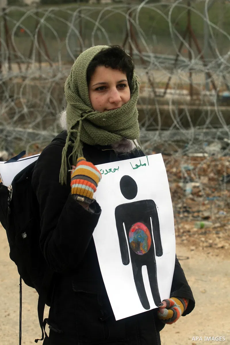 Palestinian protestors demonstrate at the entrance to Ofer Prison near Ramallah in the Occupied West Bank to support female prisoner Hanaa al-Shalabi (portrait) who was freed in a prisoner swap with Israel but was re-arr...