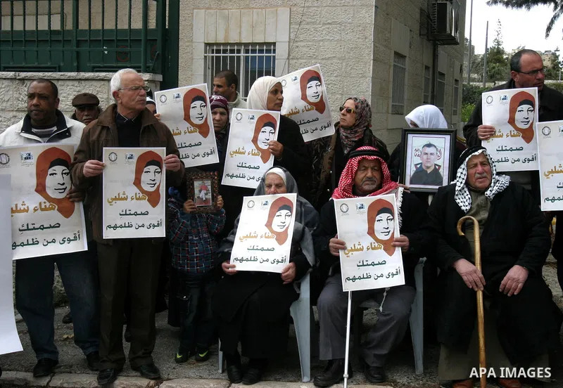 Palestinians hold portraits of jailed compatriot Hana Shalabi, a female Palestinian prisoner jailed in Israel who has been on hunger strike for 31 days, in Jerusalem, 17 March 2012. Palestinian sources said that Shalabi...