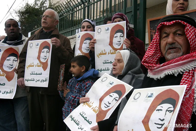 Palestinians hold portraits of jailed compatriot Hana Shalabi, a female Palestinian prisoner jailed in Israel who has been on hunger strike for 31 days, in Jerusalem, 17 March 2012. Palestinian sources said that Shalabi...