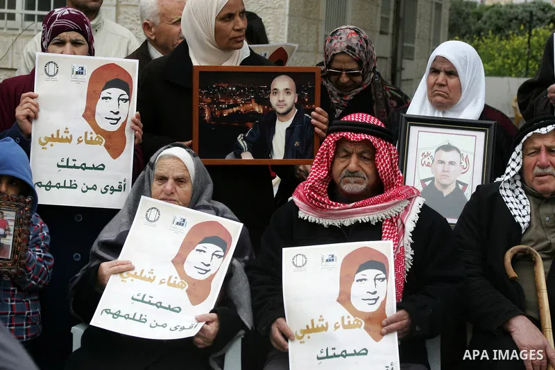Palestinians hold portraits of jailed compatriot Hana Shalabi, a female Palestinian prisoner jailed in Israel who has been on hunger strike for 31 days, in Jerusalem, 17 March 2012. Palestinian sources said that Shalabi...
