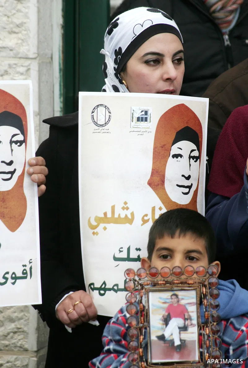 Palestinians hold portraits of jailed compatriot Hana Shalabi, a female Palestinian prisoner jailed in Israel who has been on hunger strike for 31 days, in Jerusalem, 17 March 2012. Palestinian sources said that Shalabi...