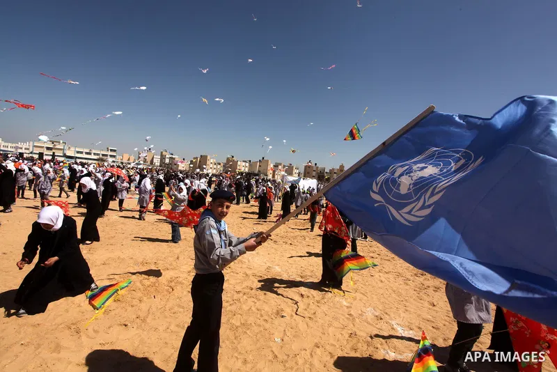 Palestinian children fly kites to show their solidarity with the Japanese people near a Japanese-funded housing project in Khan Younis in the southern Gaza Strip March 18, 2012. The event was organized by the United Nati...