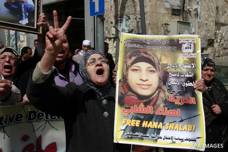 Palestinian women hold portraits of jailed compatriot Hana Shalabi, a female Palestinian prisoner jailed in Israel who has been on hunger strike for 33 days, outside the Red Cross building in the West Bank city of Nablus...