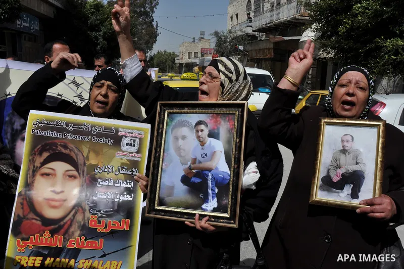 Palestinian women hold portraits of jailed compatriot Hana Shalabi, a female Palestinian prisoner jailed in Israel who has been on hunger strike for 33 days, outside the Red Cross building in the West Bank city of Nablus...