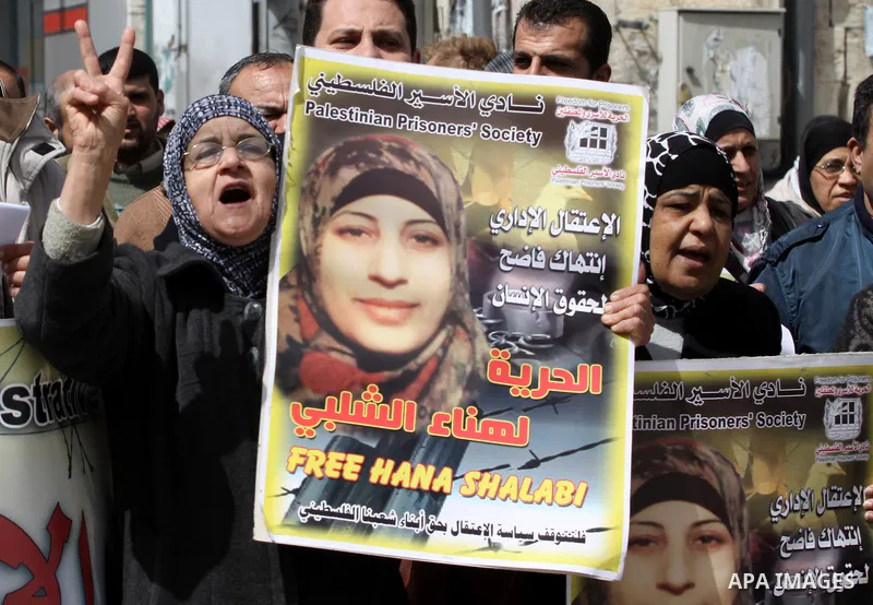 Palestinian women hold portraits of jailed compatriot Hana Shalabi, a female Palestinian prisoner jailed in Israel who has been on hunger strike for 33 days, outside the Red Cross building in the West Bank city of Nablus...