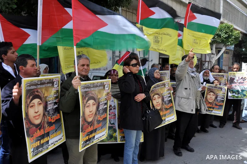Palestinian women hold portraits of jailed compatriot Hana Shalabi, a female Palestinian prisoner jailed in Israel who has been on hunger strike for 33 days, outside the Red Cross building in the West Bank city of Nablus...