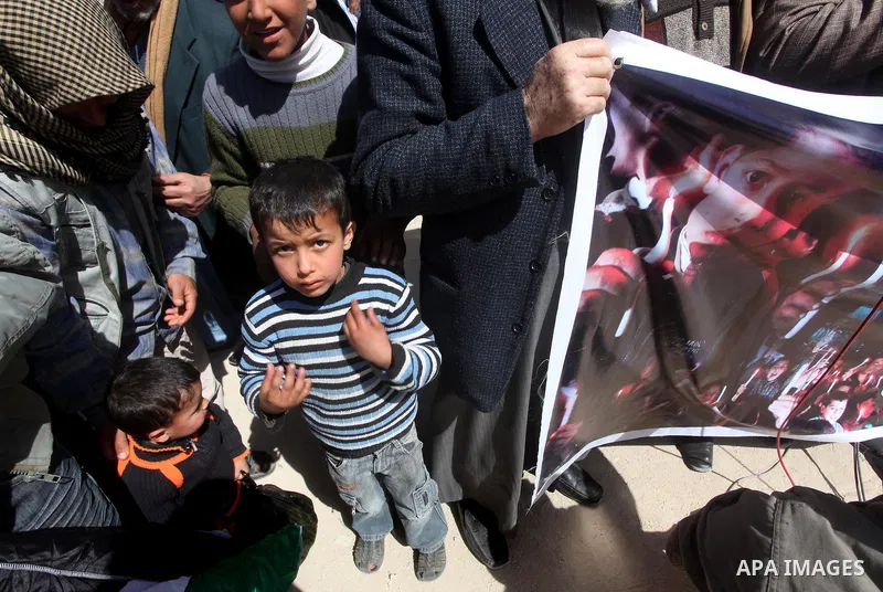Palestinian demonstrators wave national flags during a protest in the Rafah border crossing with Egypt on March 19, 2012, demanding Egypt provide the Gaza Strip with electricity and fuel. The Palestinian energy authority...