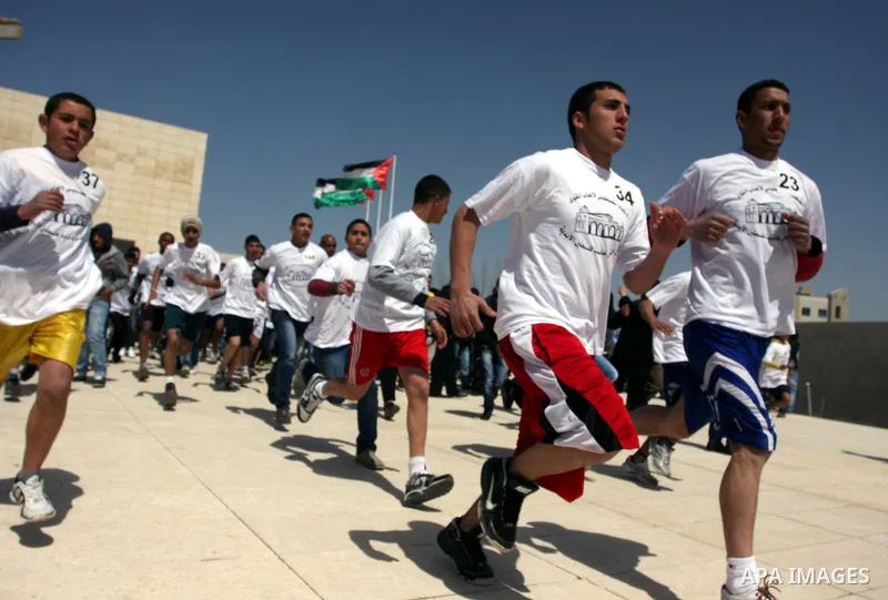 Palestinian youths participating in the Marathon "Jerusalem is the eternal capital of Palestine", which was launched in front of the tomb of President easer President Arafat in Ramallah, West Bank, March 19, 2012 ". Phot...