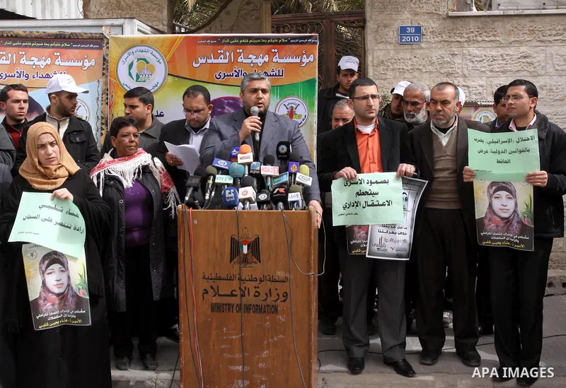 Palestinian employees of the information government office demonstrate in solidarity with Hana'a Shalabi, a female Palestinian prisoner jailed in Israel who has been on hunger strike for 34 days, outside the Red Cross bu...