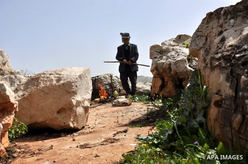 Palestinian shepherd Abu Jaafar makes a tea by a fire in Biet Leed village near the West Bank city of Tulkarem, 20 March 2012. Photo by Nedal Eshtayah