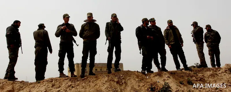 Palestinian security stand guard during a protest by women near the Rafah border crossing with Egypt in the southern Gaza Strip on March 20, 2012 demanding the Egyptian authorities to provide fuel for the power station i...