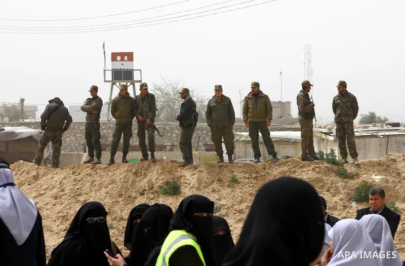 Palestinian security stand guard during a protest by women near the Rafah border crossing with Egypt in the southern Gaza Strip on March 20, 2012 demanding the Egyptian authorities to provide fuel for the power station i...