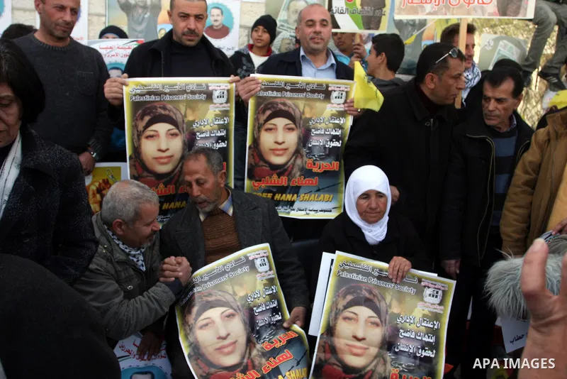 Palestinian women hold portraits of Islamic Jihad supporter Hana Shalabi, a female Palestinian prisoner jailed in Israel who has been on hunger strike for 35 days, during a rally in solidarity with Palestinian prisoners...