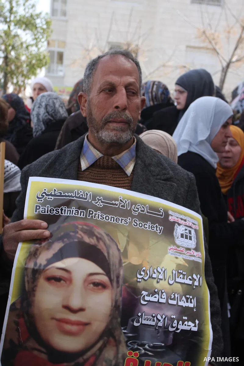 Palestinian women hold portraits of Islamic Jihad supporter Hana Shalabi, a female Palestinian prisoner jailed in Israel who has been on hunger strike for 35 days, during a rally in solidarity with Palestinian prisoners...