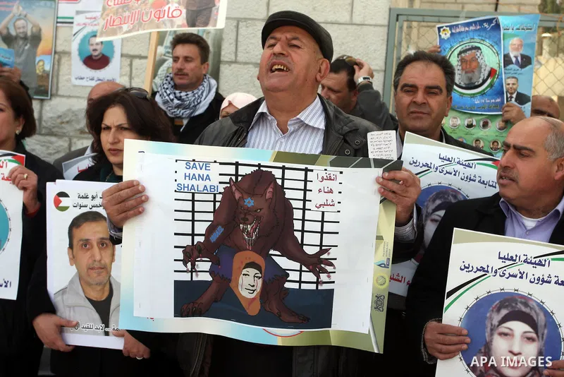 Palestinian women hold portraits of Islamic Jihad supporter Hana Shalabi, a female Palestinian prisoner jailed in Israel who has been on hunger strike for 35 days, during a rally in solidarity with Palestinian prisoners...