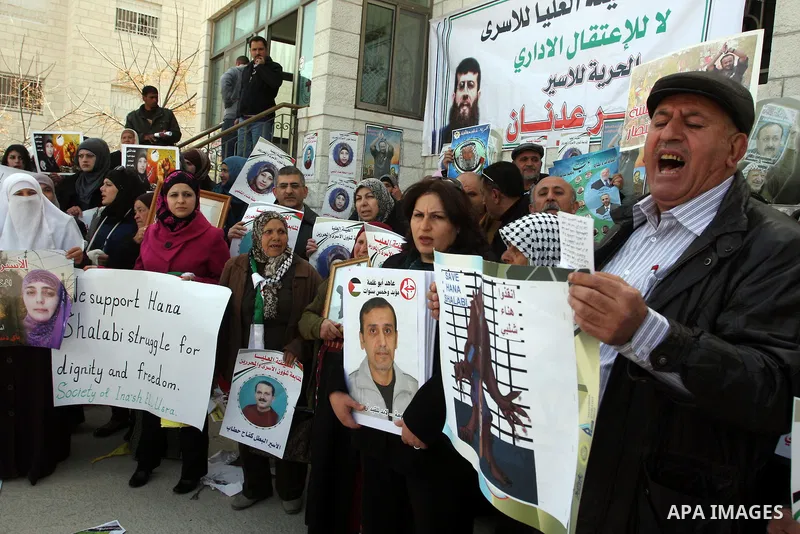Palestinian women hold portraits of Islamic Jihad supporter Hana Shalabi, a female Palestinian prisoner jailed in Israel who has been on hunger strike for 35 days, during a rally in solidarity with Palestinian prisoners...