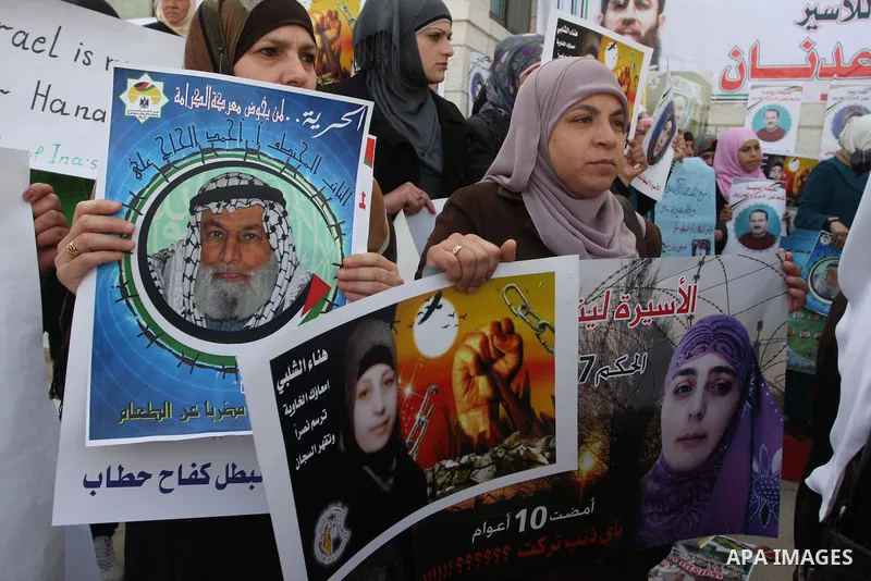 Palestinian women hold portraits of Islamic Jihad supporter Hana Shalabi, a female Palestinian prisoner jailed in Israel who has been on hunger strike for 35 days, during a rally in solidarity with Palestinian prisoners...