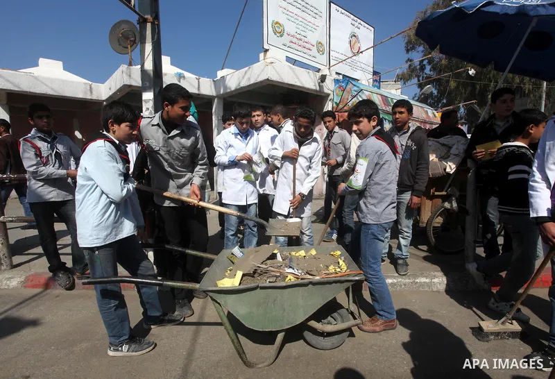 Palestinian students volunteer clean the streets during the campaign "Cleanliness " in Gaza City on Mar. 22, 2012. Photo by Ashraf Amra