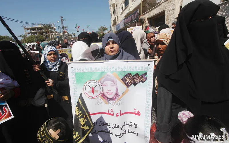 Palestinian women hold portraits of jailed compatriot Hana Shalabi, a female Palestinian prisoner jailed in Israel who has been on hunger strike for 37 days, outside the Red Cross building in Gaza City on Mar. 22, 2012....