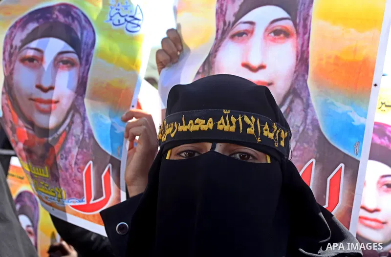 Palestinian women hold portraits of jailed compatriot Hana Shalabi, a female Palestinian prisoner jailed in Israel who has been on hunger strike for 37 days, outside the Red Cross building in Gaza City on Mar. 22, 2012....