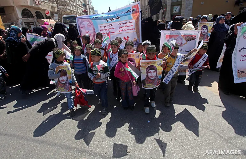 Palestinians hold portraits of jailed compatriot Hana Shalabi, a female Palestinian prisoner jailed in Israel who has been on hunger strike for 37 days, outside the Red Cross building in Gaza City on Mar. 22, 2012. Pales...
