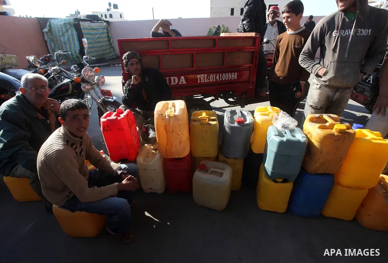 Palestinians wait to fill containers with fuel at a petrol station in Bit Lahia in the northern Gaza Strip March 22, 2012. Palestinians in the Gaza Strip are suffering a crisis of dry petrol pumps and frequent blackouts...
