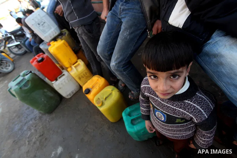 Palestinians wait to fill containers with fuel at a petrol station in Bit Lahia in the northern Gaza Strip March 22, 2012. Palestinians in the Gaza Strip are suffering a crisis of dry petrol pumps and frequent blackouts...