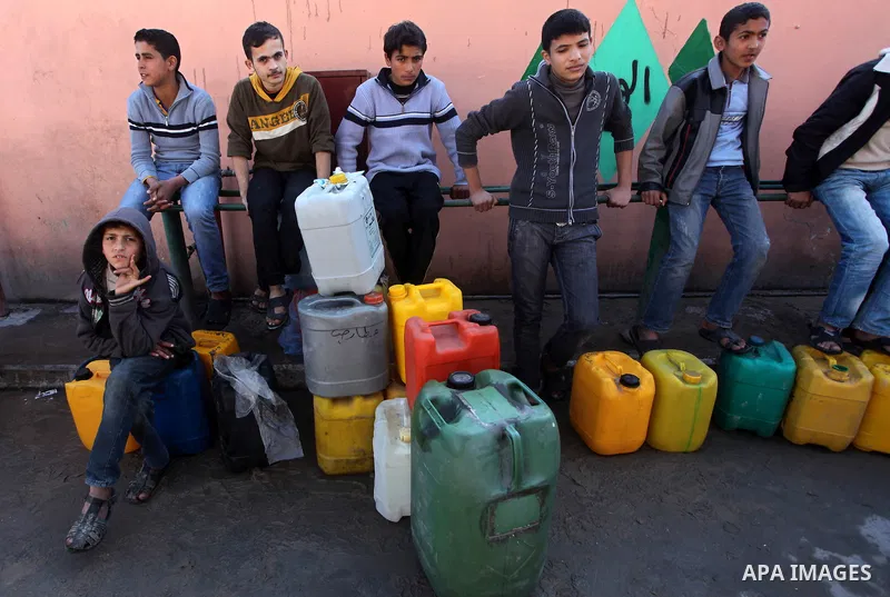 Palestinians wait to fill containers with fuel at a petrol station in Bit Lahia in the northern Gaza Strip March 22, 2012. Palestinians in the Gaza Strip are suffering a crisis of dry petrol pumps and frequent blackouts...