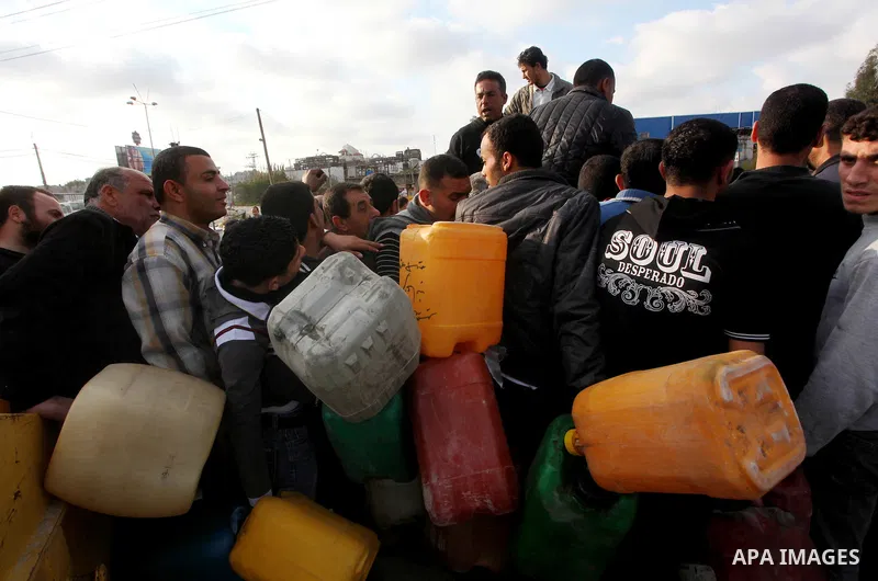 Palestinians wait to fill containers with fuel at a petrol station in Bit Lahia in the northern Gaza Strip March 22, 2012. Palestinians in the Gaza Strip are suffering a crisis of dry petrol pumps and frequent blackouts...