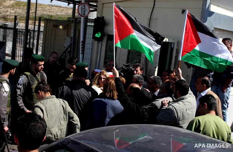 Israeli soldiers stand guard in front of Palestinian protesters demonstrating against the relocation of an Israeli road gate in the village of Beit Iksa in the occupied West Bank between Ramallah and Jerusalem on March 2...