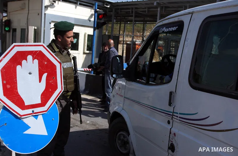 Israeli soldiers stand guard in front of Palestinian protesters demonstrating against the relocation of an Israeli road gate in the village of Beit Iksa in the occupied West Bank between Ramallah and Jerusalem on March 2...