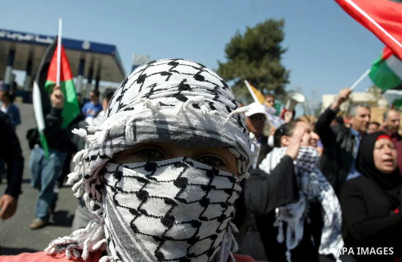 Palestinian protestors run away from tear gas fired by Israeli soldiers during clashes between Israeli soldiers and a group of Palestinian and foreign demonstrators in the West Bank village of Nabi Saleh, near Ramallah o...