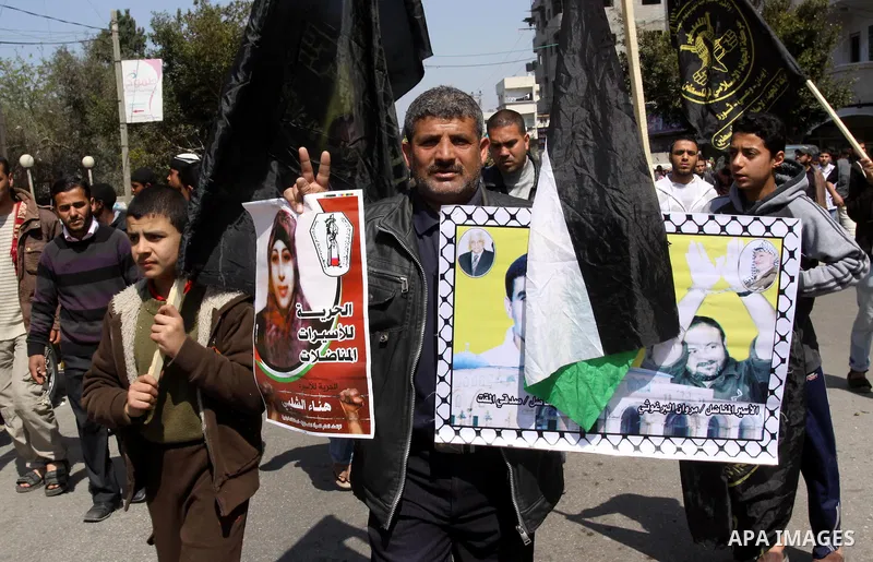 Palestinian Islamic Jihad supporters take part in a rally in support of Hana Shalabi and calling for the release of Palestinian prisoners held in Israeli jails, in Gaza City March 23, 2012. The deteriorating health of Sh...