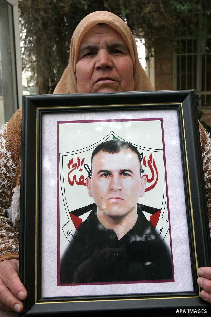 Palestinians hold portraits of relatives detained in Israeli prisons as they protest to demand for their release during a demonstration in support of Hanaa al-Shalabi outside Damascus gate, in the old city of Jerusalem,...