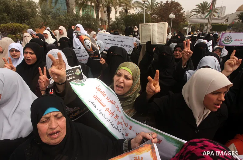 A Palestinian Hamas muslim women next to a poster of Hana Shalaby during a rally at the Palestinian Parliament in Gaza City on, 25 March 2012. Reports state that Hanna Shalabe a Palestinian prisoner in an Israel prison h...