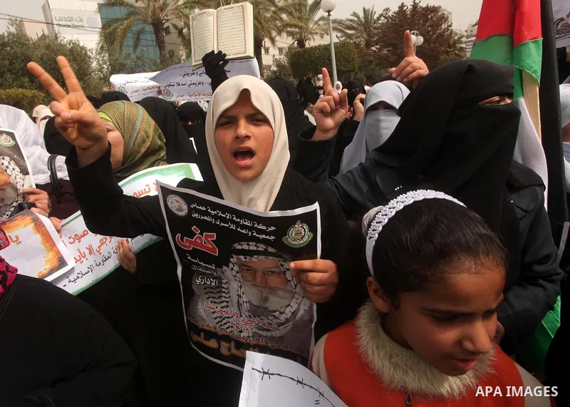 A Palestinian Hamas muslim women next to a poster of Hana Shalaby during a rally at the Palestinian Parliament in Gaza City on, 25 March 2012. Reports state that Hanna Shalabe a Palestinian prisoner in an Israel prison h...