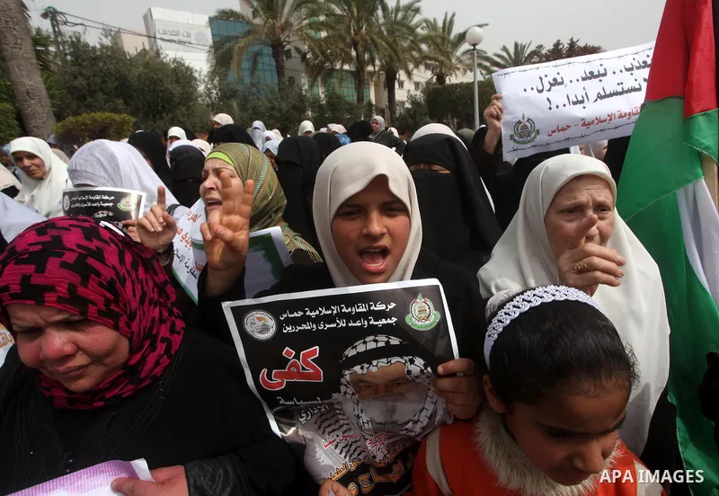 A Palestinian Hamas muslim women next to a poster of Hana Shalaby during a rally at the Palestinian Parliament in Gaza City on, 25 March 2012. Reports state that Hanna Shalabe a Palestinian prisoner in an Israel prison h...