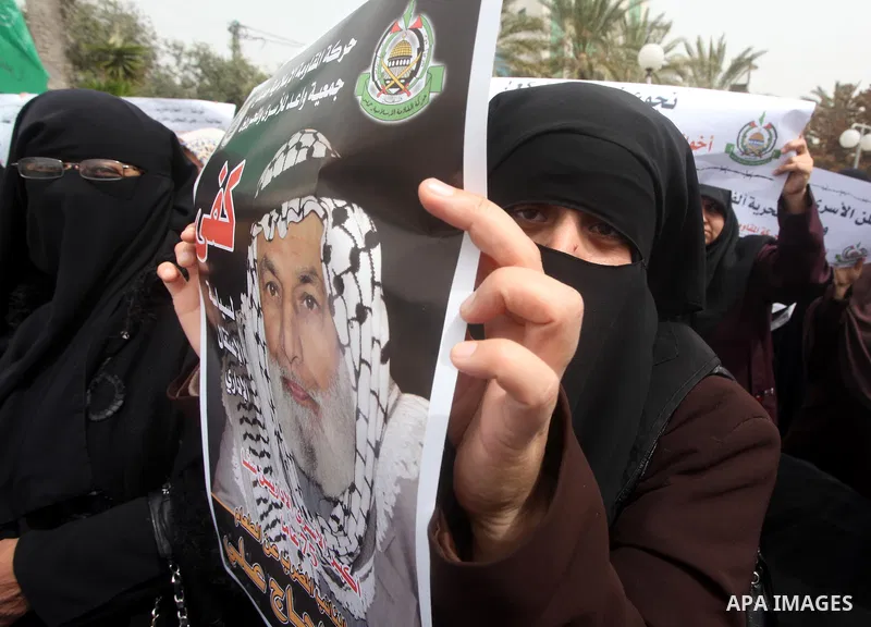A Palestinian Hamas muslim women next to a poster of Hana Shalaby during a rally at the Palestinian Parliament in Gaza City on, 25 March 2012. Reports state that Hanna Shalabe a Palestinian prisoner in an Israel prison h...