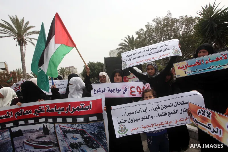 A Palestinian Hamas muslim women next to a poster of Hana Shalaby during a rally at the Palestinian Parliament in Gaza City on, 25 March 2012. Reports state that Hanna Shalabe a Palestinian prisoner in an Israel prison h...