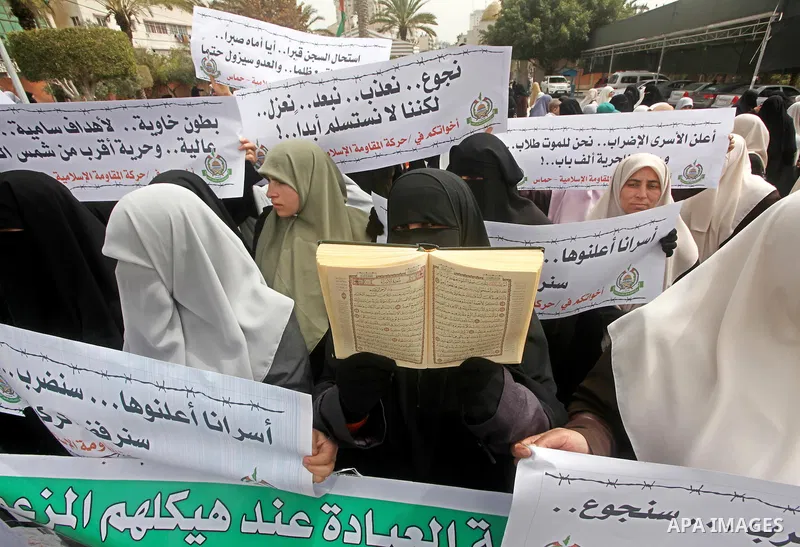 A Palestinian Hamas muslim women next to a poster of Hana Shalaby during a rally at the Palestinian Parliament in Gaza City on, 25 March 2012. Reports state that Hanna Shalabe a Palestinian prisoner in an Israel prison h...