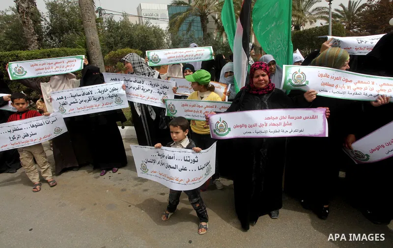 A Palestinian Hamas muslim women next to a poster of Hana Shalaby during a rally at the Palestinian Parliament in Gaza City on, 25 March 2012. Reports state that Hanna Shalabe a Palestinian prisoner in an Israel prison h...