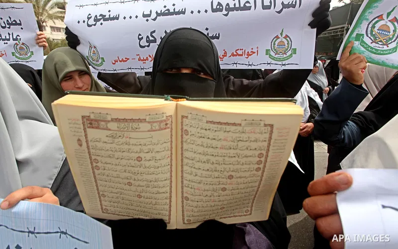 A Palestinian Hamas muslim women next to a poster of Hana Shalaby during a rally at the Palestinian Parliament in Gaza City on, 25 March 2012. Reports state that Hanna Shalabe a Palestinian prisoner in an Israel prison h...