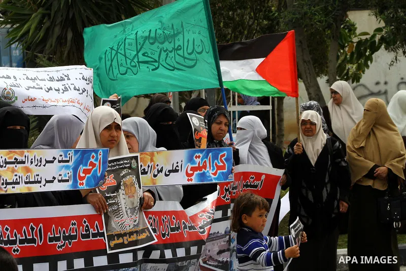 A Palestinian Hamas muslim women next to a poster of Hana Shalaby during a rally at the Palestinian Parliament in Gaza City on, 25 March 2012. Reports state that Hanna Shalabe a Palestinian prisoner in an Israel prison h...