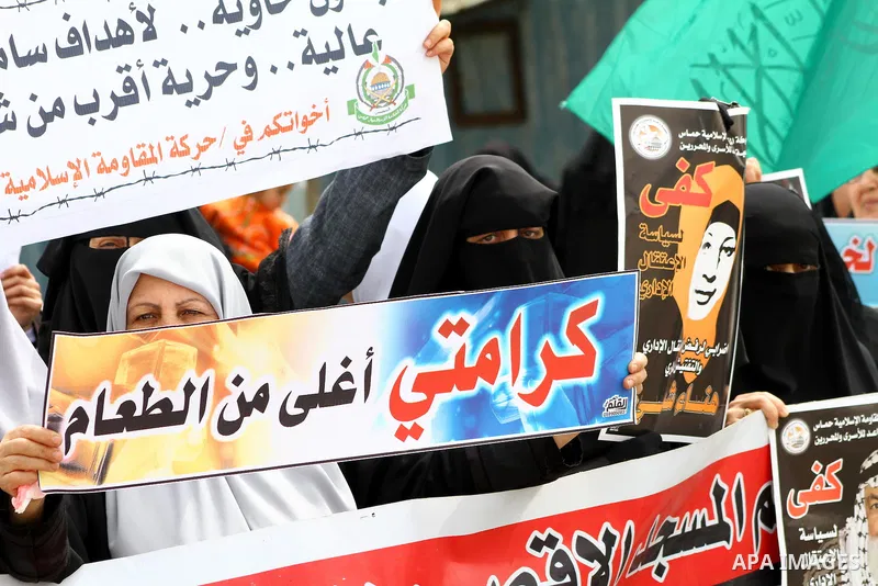 A Palestinian Hamas muslim women next to a poster of Hana Shalaby during a rally at the Palestinian Parliament in Gaza City on, 25 March 2012. Reports state that Hanna Shalabe a Palestinian prisoner in an Israel prison h...