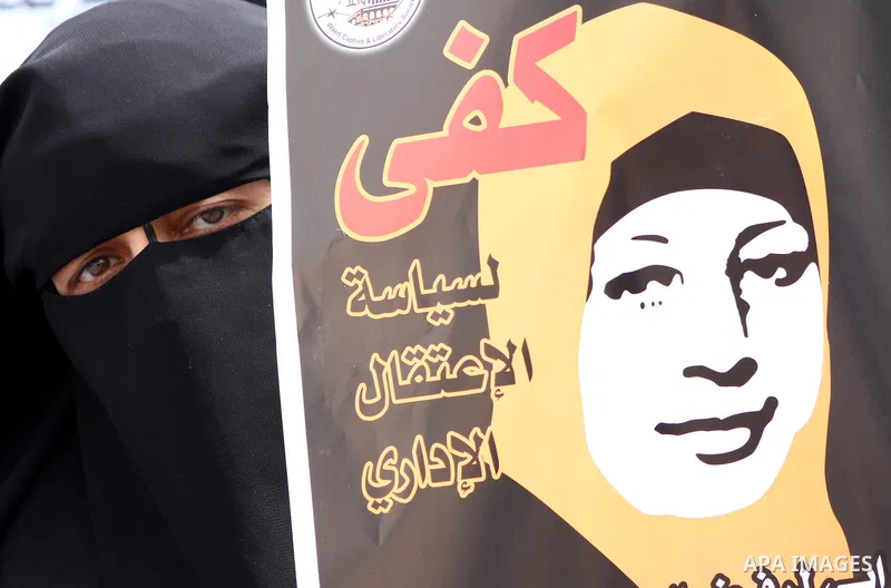 A Palestinian Hamas muslim women next to a poster of Hana Shalaby during a rally at the Palestinian Parliament in Gaza City on, 25 March 2012. Reports state that Hanna Shalabe a Palestinian prisoner in an Israel prison h...